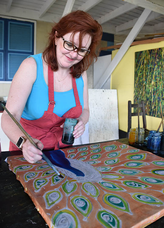 Painting dye into the peacock and feathers - Christina Erickson batik